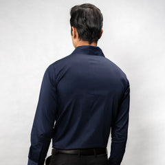 Man wearing a navy blue shirt against a white background