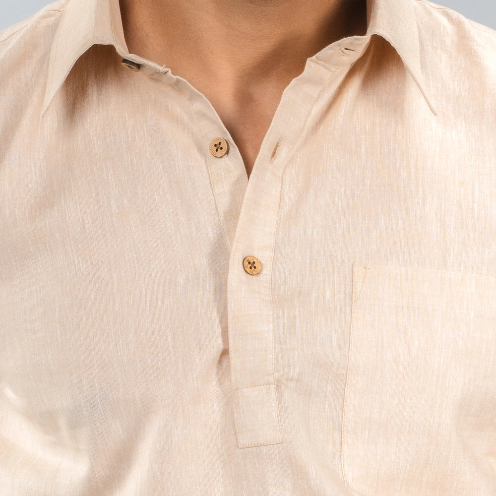 Close-up of a beige button-up lenin shirt with a neutral background