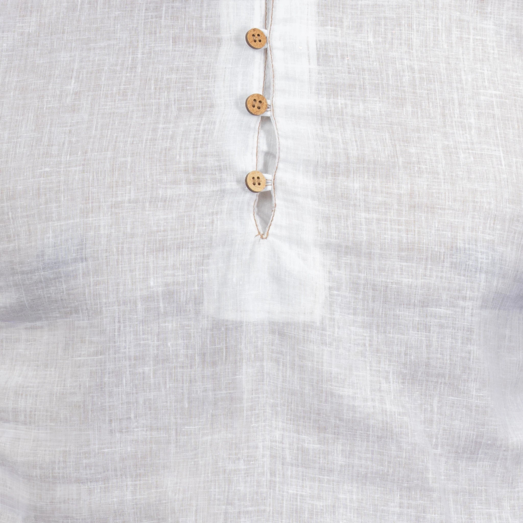Close-up of a linen fabric with wooden buttons on a white background