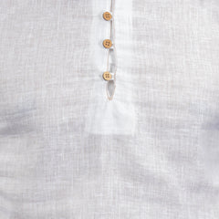 Close-up of a linen fabric with wooden buttons on a white background