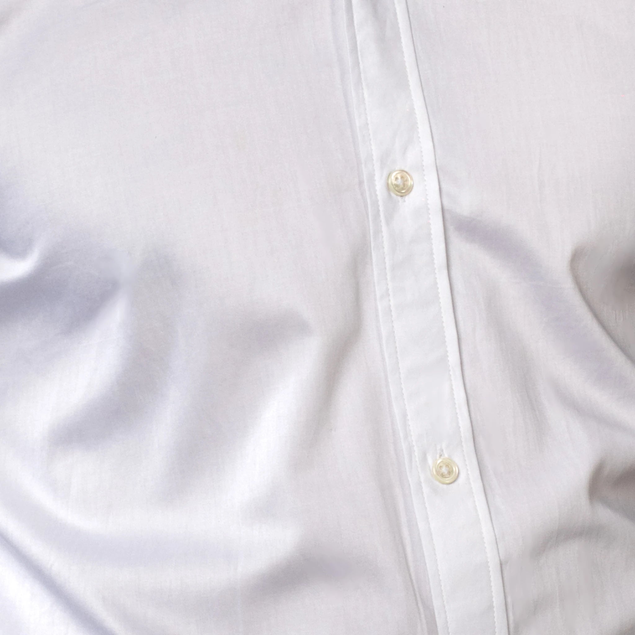 Close-up of a white shirt with button details brand appril