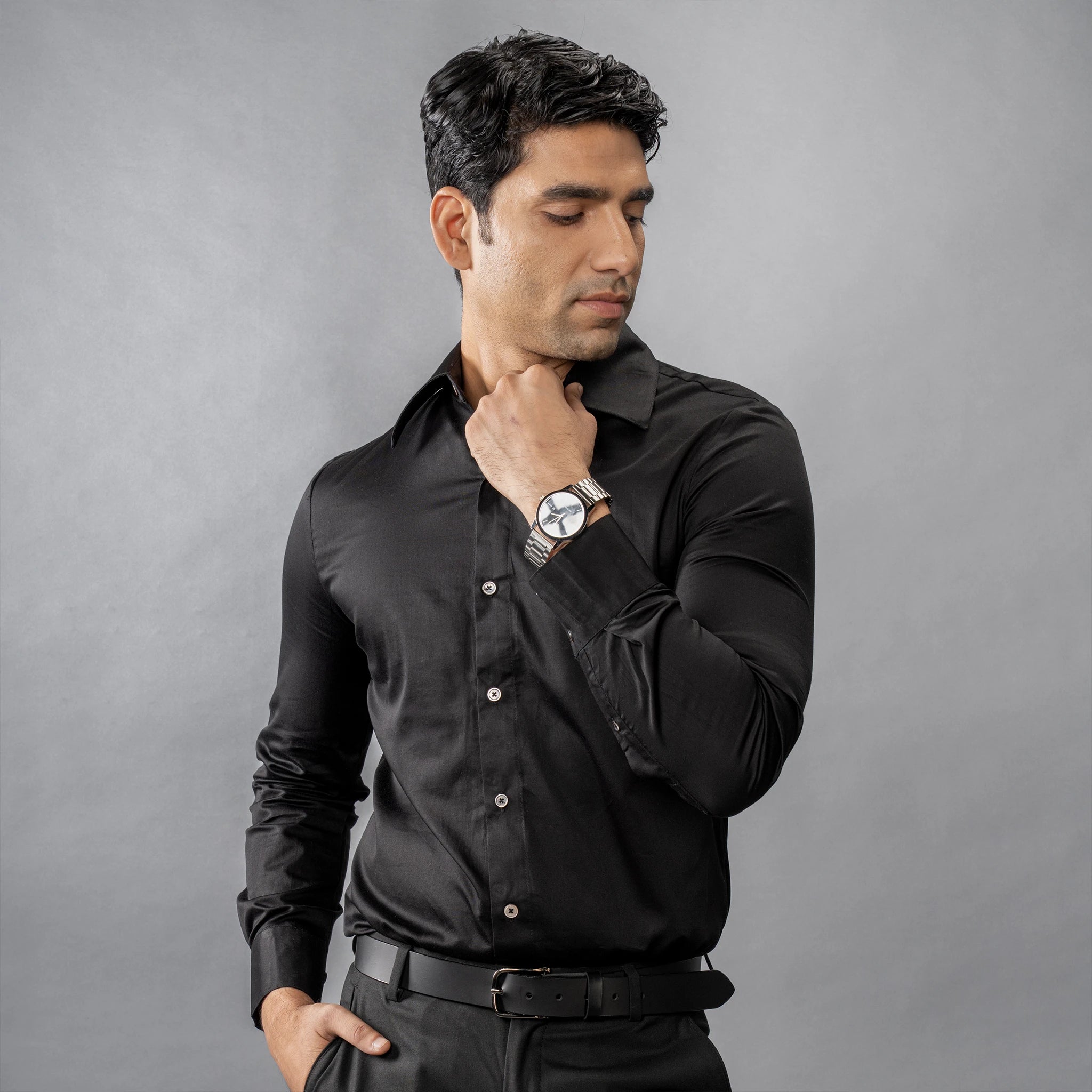Man wearing a Continental Royale (Black Beauty) shirt and watch against a grey background