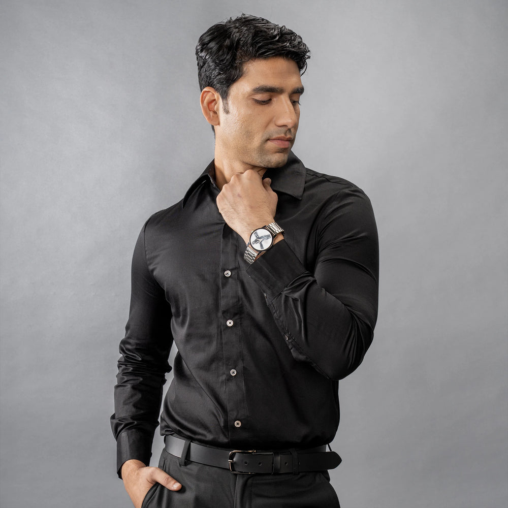 Man wearing a Continental Royale (Black Beauty) shirt and watch against a grey background