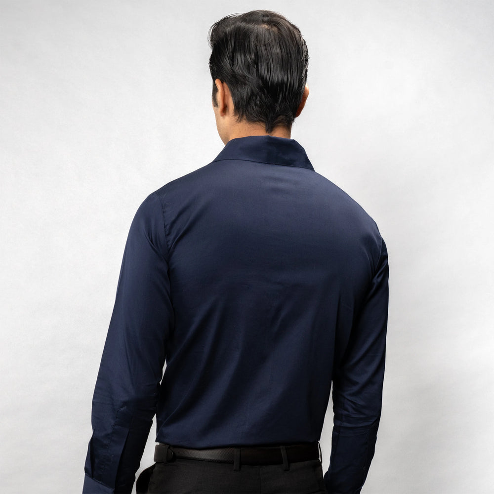 Man wearing a navy blue shirt against a white background
