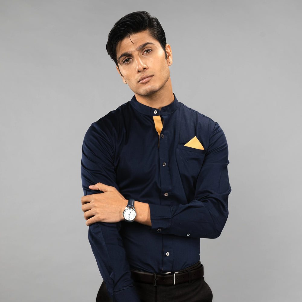 Man wearing a premium navy blue shirt on a grey background