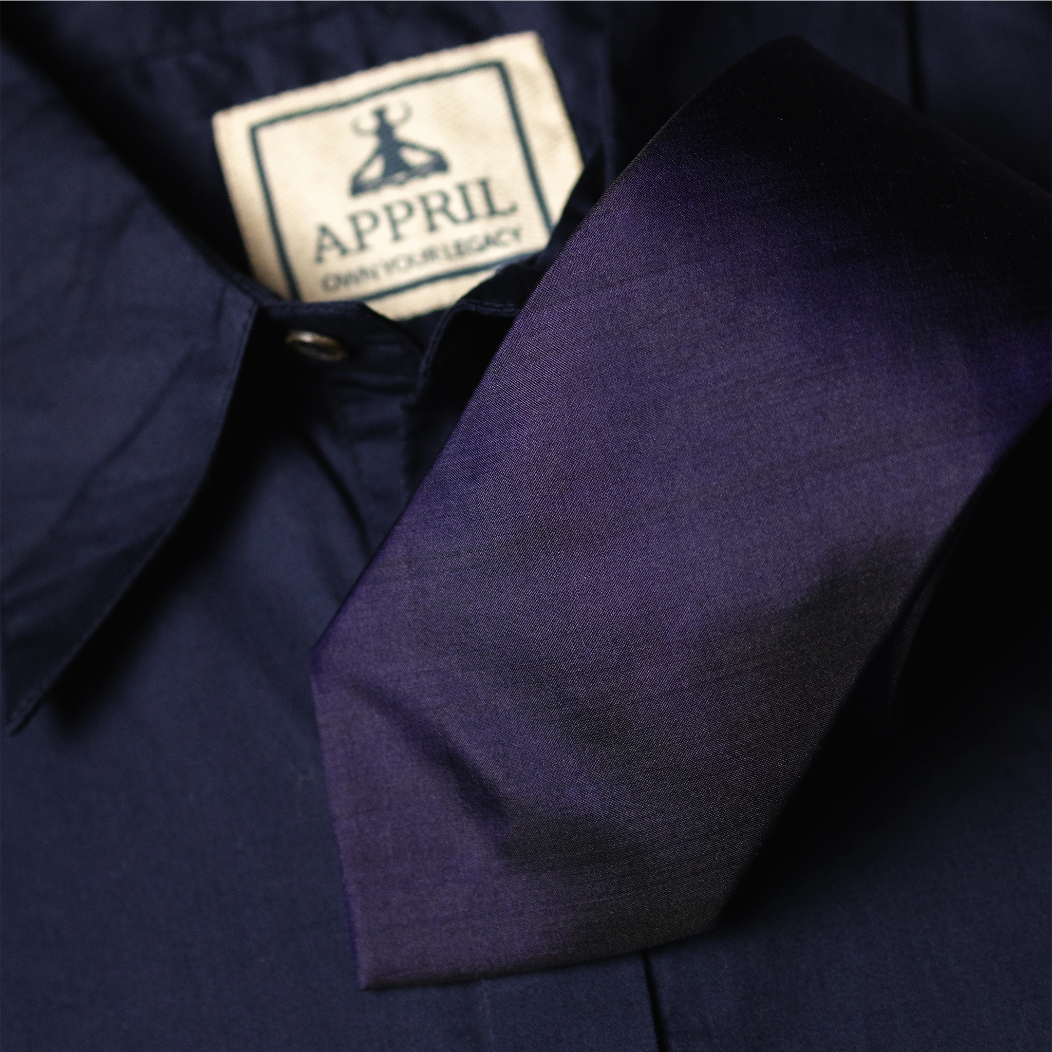 Navy blue Silk fabric Tie with a navy blue shirt in background