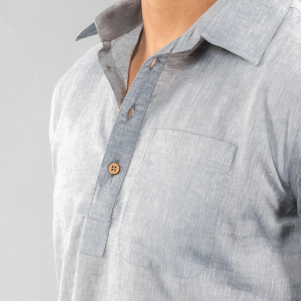 Close-up of a person wearing a Faded Denim button-up shirt with a collar on a plain background