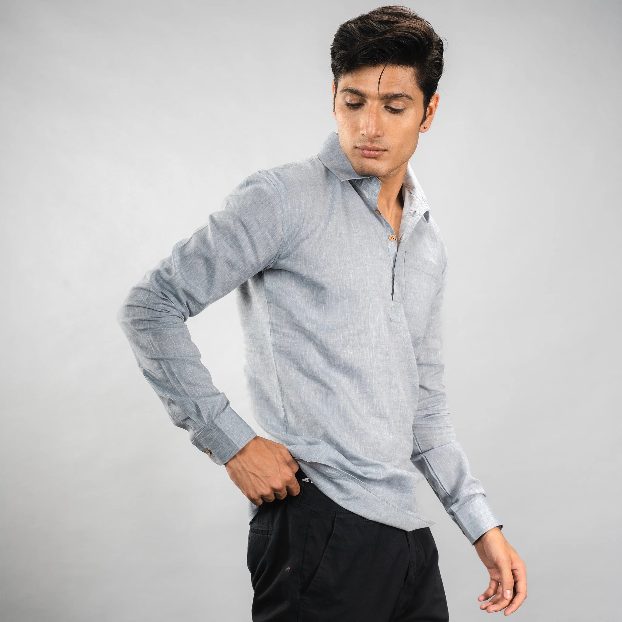 model side posing casual‑luxury linen half‑placket shirt with coconut shell buttons and a relaxed fit