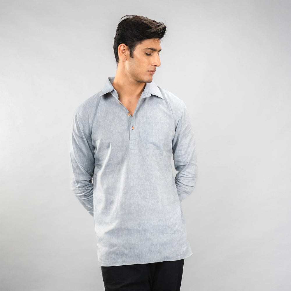 Man wearing a Faded Denim long-sleeve shirt against a plain background