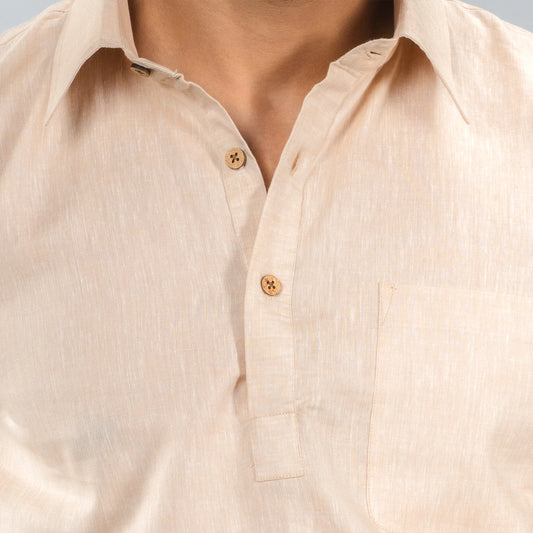 Close-up of a beige button-up lenin shirt with a neutral background