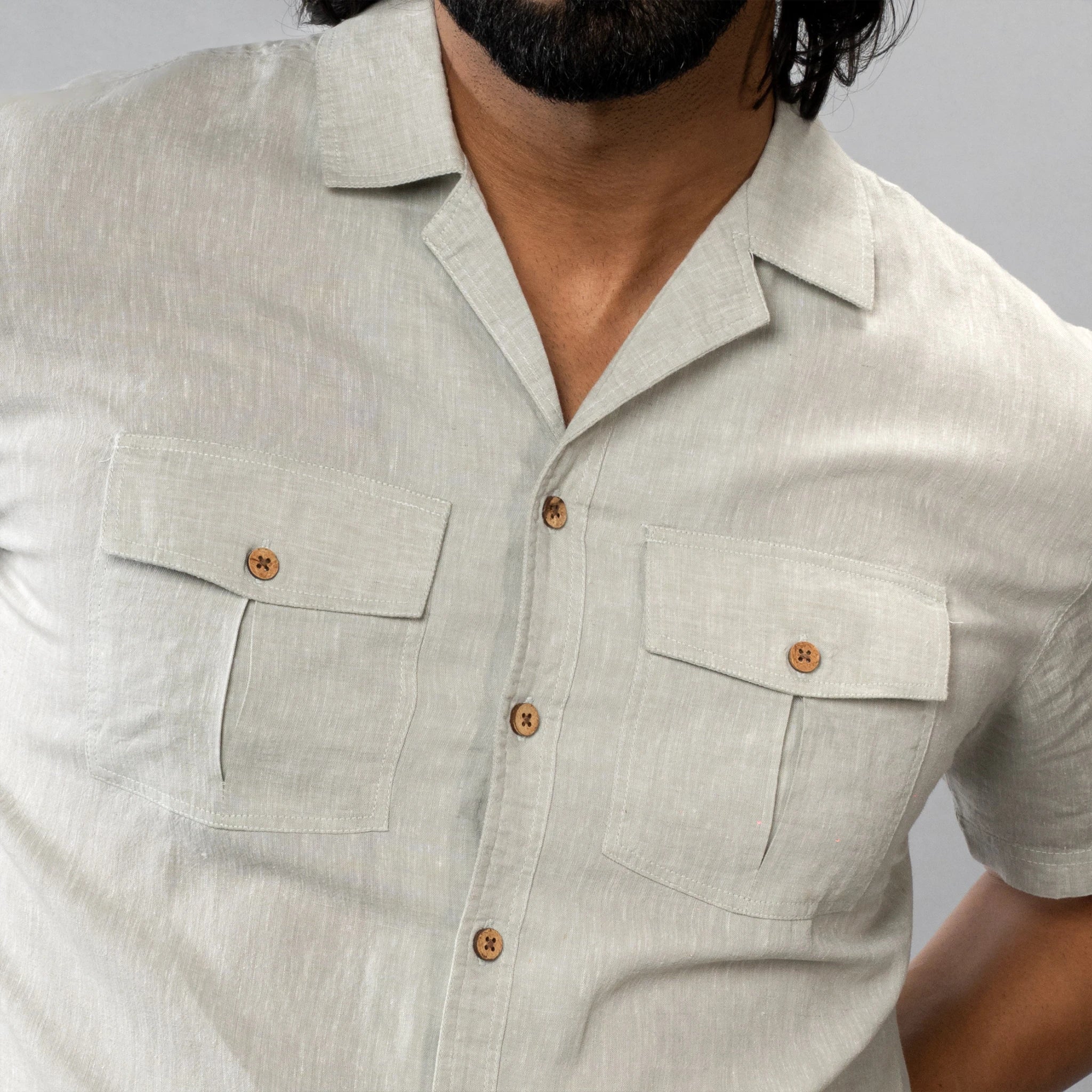 olive green short-sleeve shirt with shell buttons button details 