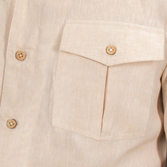 Close-up of a beige shirt with natural coconut shell button details