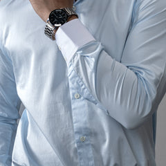 close up of model wearing a brand appril a contrast white club collar and cuffs, this Giza Cotton shirt blends legacy charm with modern precision. 