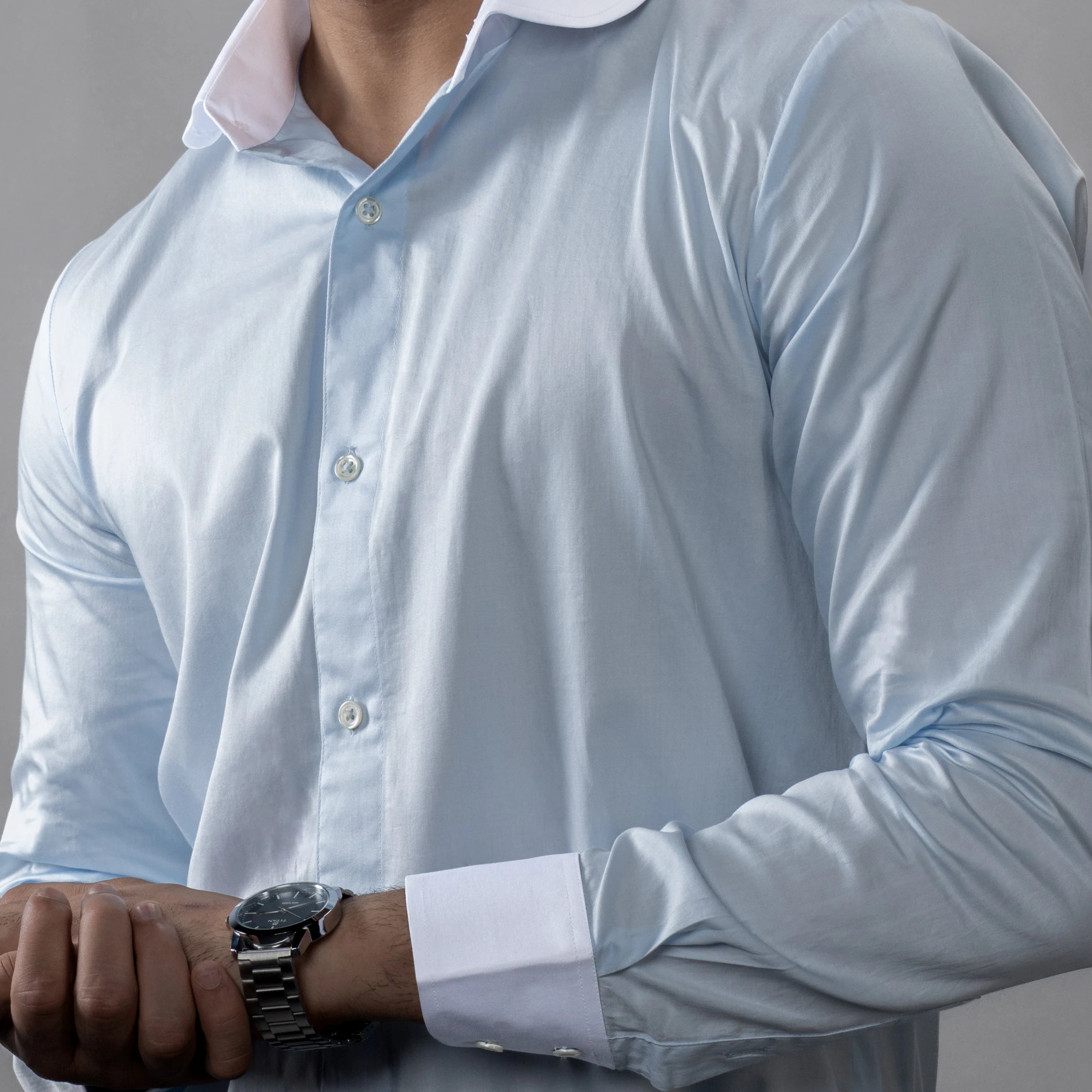 a contrast white club collar and cuffs, this Giza Cotton shirt blends legacy charm with modern precision. and a watch on a neutral background